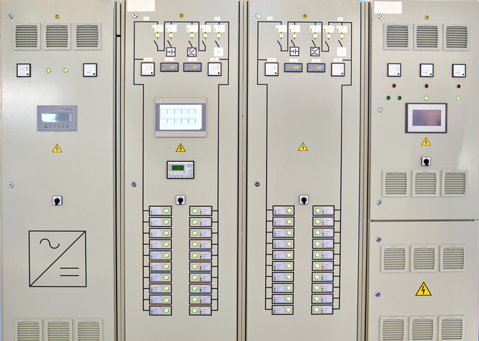 Industrial electrical cabinet with automated switching components and capacitors installed during the Power Factor Upgrade at Alliance Plant to reduce reactive power and energy costs.
